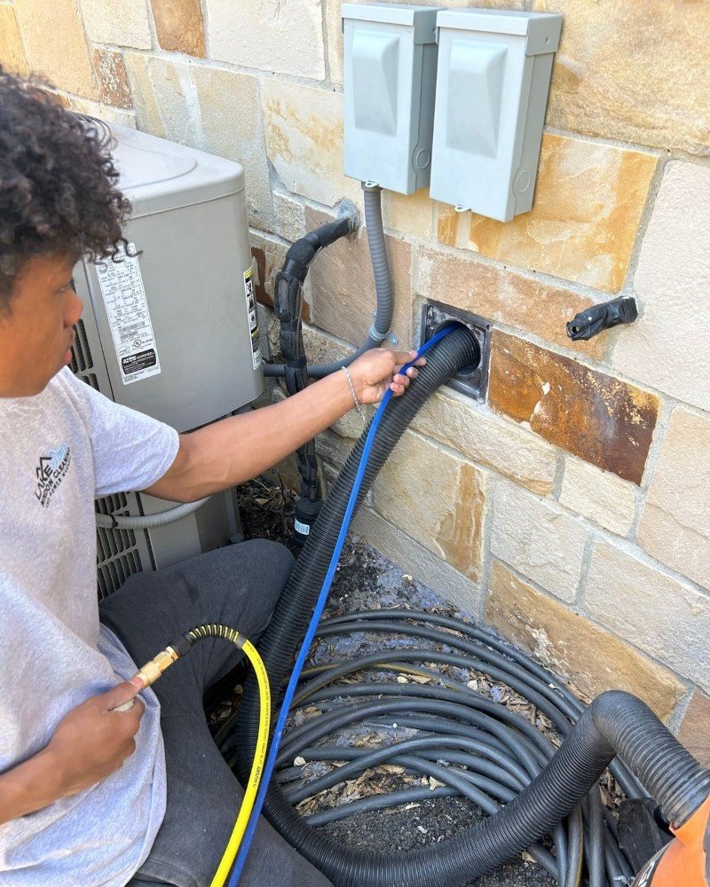 Technician cleaning a dryer vent line in a Brooklyn home