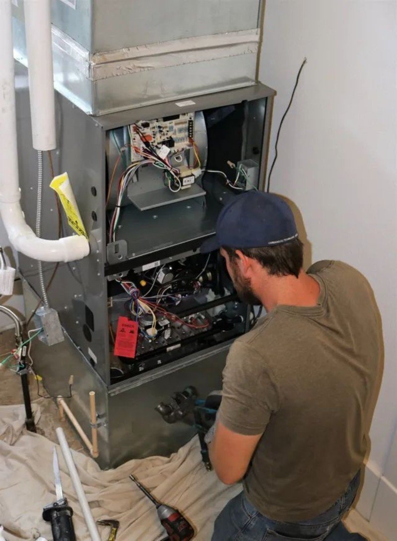 Technician performing careful AC coil cleaning in Brooklyn