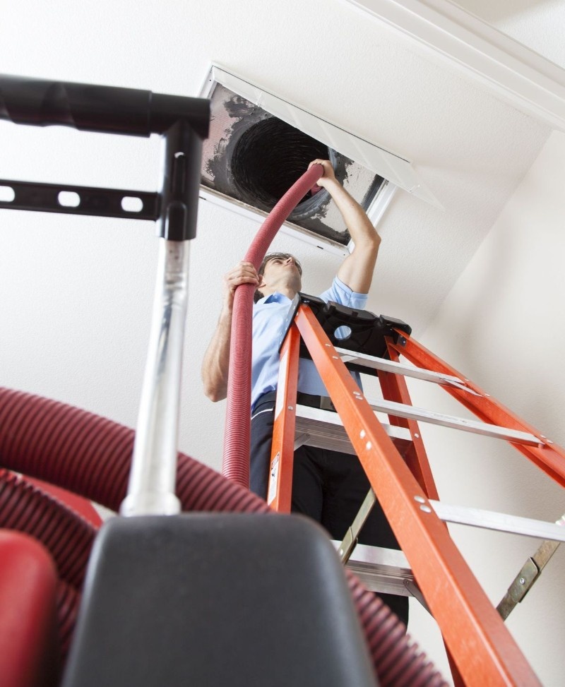 Technician performing air duct cleaning on-site in Brooklyn, NY